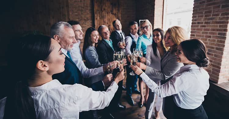 Corporate retreat with employees toasting 